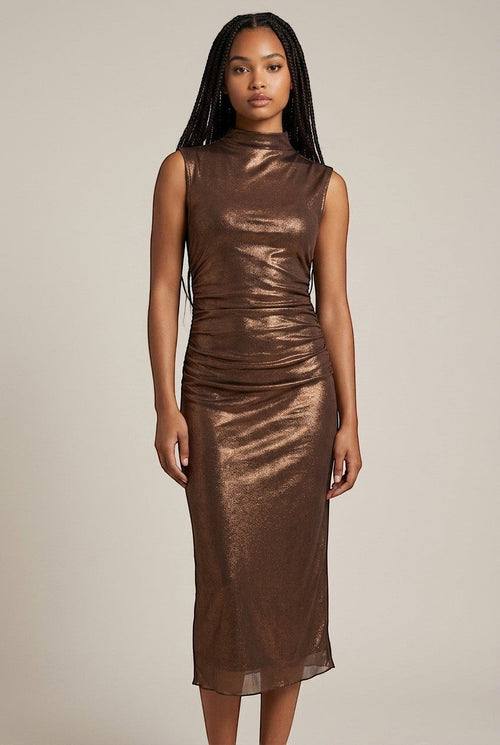 Model wearing a Roxanne's bronze shimmer mock neck sleeveless midi dress with ruched detailing for evening wear.